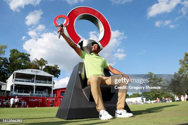 Tony Finau of the United States poses with the trophy after winning the Rocket Mortgage Classic at Detroit Golf Club on July 31, 2022 in Detroit,...