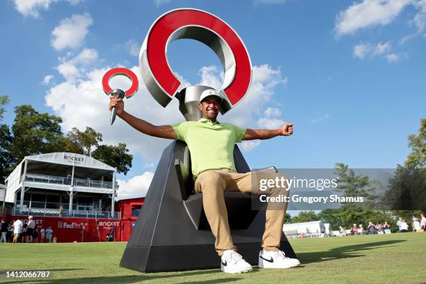 Tony Finau of the United States poses with the trophy after winning the Rocket Mortgage Classic at Detroit Golf Club on July 31, 2022 in Detroit,...