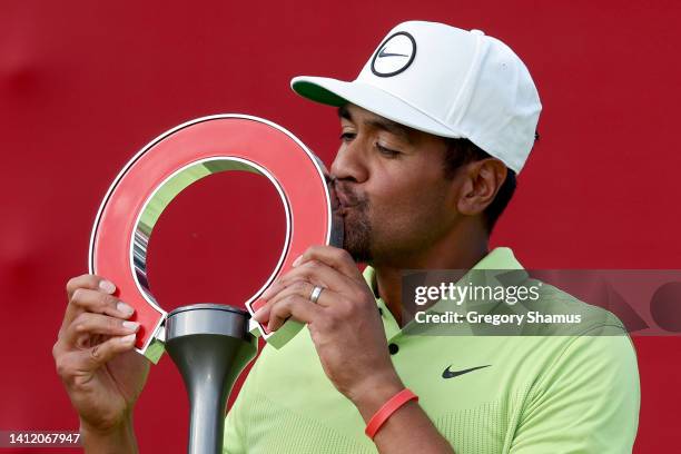 Tony Finau of the United States kisses the trophy after winning the Rocket Mortgage Classic at Detroit Golf Club on July 31, 2022 in Detroit,...