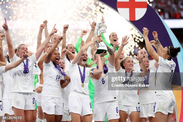 Leah Williamson and Millie Bright of England lift the trophy after their teams victory during the UEFA Women's Euro 2022 final match between England...