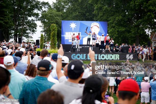 Fans cheer as Henrik Stenson of Majesticks GC poses with the first place individual trophy alongside his caddie Gareth Lord, second place Matt Wolff...