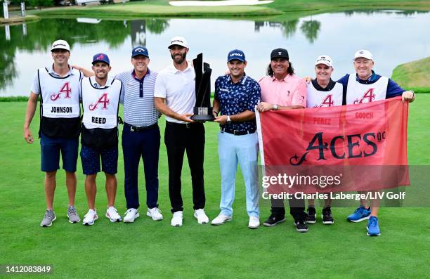 Talor Gooch, team Captain Dustin Johnson, Patrick Reed and Pat Perez of 4 Aces GC celebrate with the trophy and their caddies after winning first...