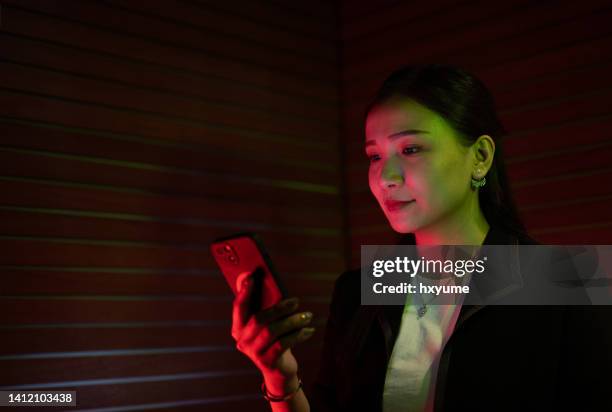 potrait of an asian chinese businessman lit by coloured led lighting - gel effect lighting stock pictures, royalty-free photos & images