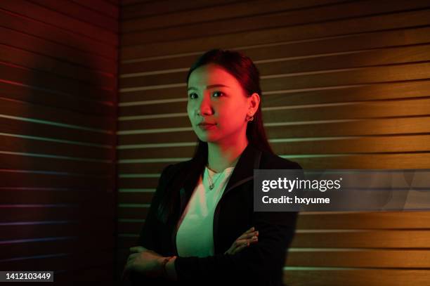 potrait of an asian chinese businessman lit by coloured led lighting - gel effect lighting stock pictures, royalty-free photos & images