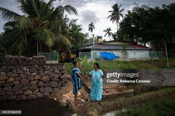 Indian farmer Poonama Rajiv speaks with a neighbour as she plants rice paddy at Kainakary in Kuttanad on July 28, 2022 in Kerala, India. India’s 2022...