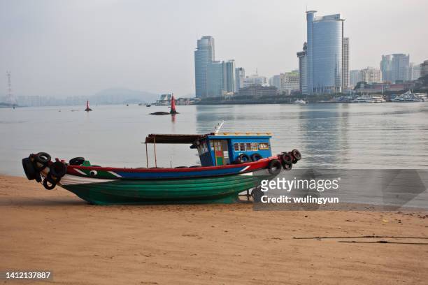 an fishing boat on the beach of gulangyu - 鼓浪嶼 ストックフォトと画像