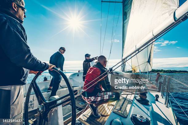 sailing crew on sailboat on regatta - rudder stock pictures, royalty-free photos & images
