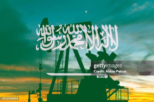 oil pump on the background of the flag of saudi arabia - saudi arabia flag stock pictures, royalty-free photos & images