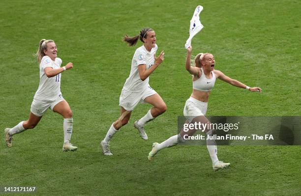 Chloe Kelly of England celebrates with teammates Jill Scott and Lauren Hemp after scoring their team's second goal during the UEFA Women's Euro 2022...