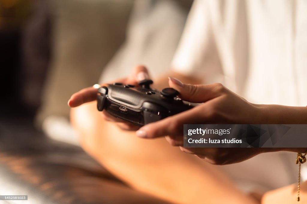 Woman using a game controller to play video games