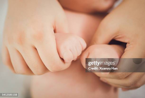 parent holding newborn baby hand - gesturing stock pictures, royalty-free photos & images