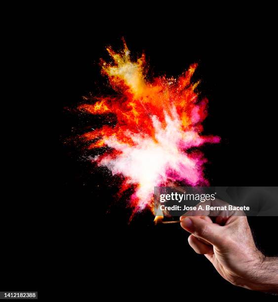 a man's hand with a match that causes an explosion with smoke. - finger blaster 個照片及圖片檔