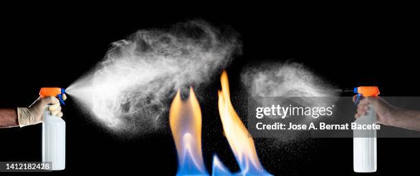 hand of a man with a fire extinguisher putting out a fire inside the house. - burst pipes stock pictures, royalty-free photos & images