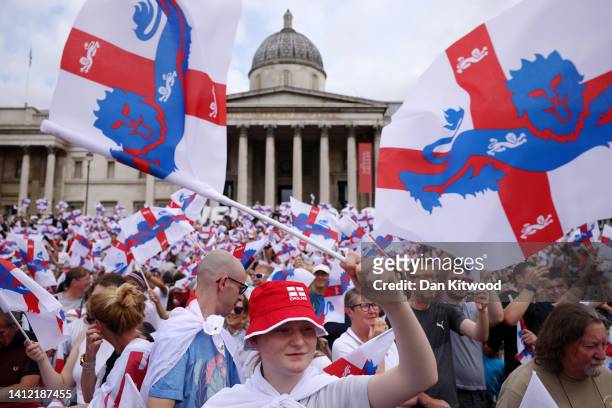 England fans celebrates as they wave flags during the England Women's Team Celebration at Trafalgar Square on August 01, 2022 in London, England. The...