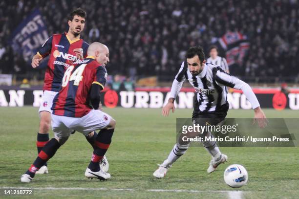 Andrea Raggi of Bologna FC competes the ball with Mirko Vucinic of Juventus FC during the Serie A match between Bologna FC and Juventus FC at Stadio...