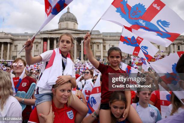 England fans wave flags as they enjoy the atmosphere during the England Women's Team Celebration at Trafalgar Square on August 01, 2022 in London,...