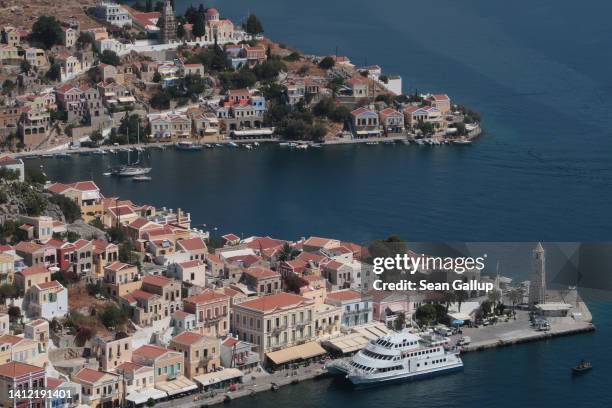 The harbor of the town of Ano Symi stands on July 28, 2022 on the island of Symi, Greece. Symi is an island in the Dodacenese in the southeastern...