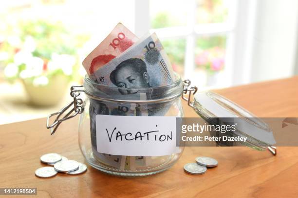 chinese currency in jar, saving for a vacation - 20 yuan note stock pictures, royalty-free photos & images