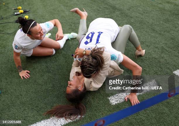 Jill Scott and Lucy Bronze of England celebrate with former player Fara Williams after winning the UEFA Women's Euro 2022 final match between England...