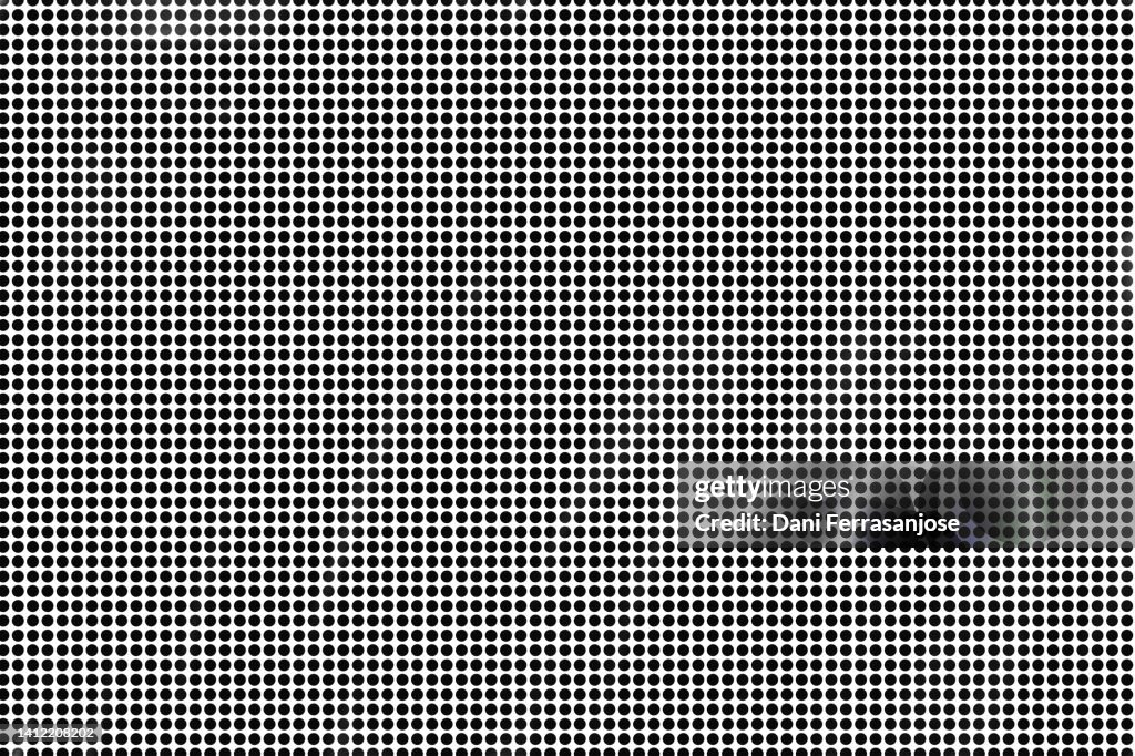 Hypnotic image of black dots on white background.
