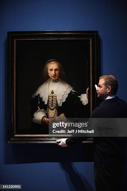 Stephen Webster, Exhibition co-ordinator, stands next to the painting Agatha Bas by Rembrandt, part of the Royal Collection on display at the Queens...