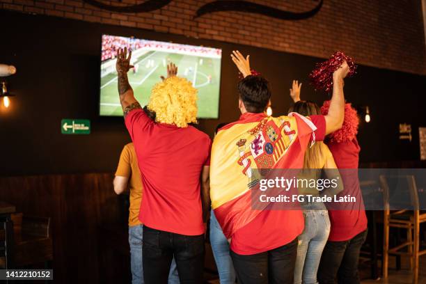 spanish friends watching a soccer game and celebrating at a bar - back in the game stock pictures, royalty-free photos & images