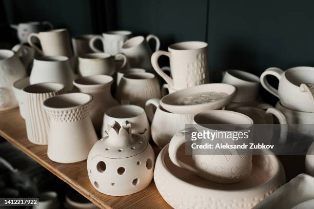 handmade ceramic tableware, pottery accessories for shopping on a wooden table in a creative studio. sale of handicraft eco-products. sustainable development. master class on making clay mugs and plates. the concept of hobby, creativity. - candle holder stock pictures, royalty-free photos & images