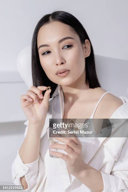 portrait beautiful young asian woman with drug pill - stock photo - national diet of japan stock pictures, royalty-free photos & images