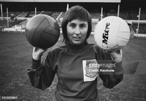 British footballer Sue Buckett, England goalkeeper, poses with two footballs, one plastic and one leather, during an England Women's training session...