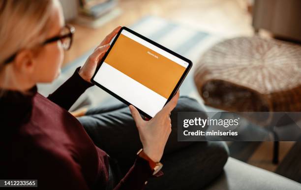 close up photo of woman hands using a digital tablet for online banking - tablet bildbanksfoton och bilder