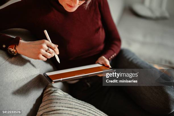 close up photo of woman hands using a digital tablet for online banking - log in stock pictures, royalty-free photos & images