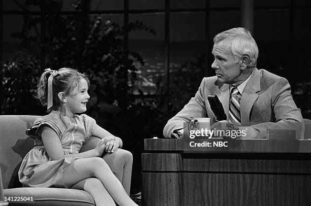 Air Date -- Pictured: Actress Drew Barrymore, host Johnny Carson -- Photo by: Gene Arias/NBCU Photo Bank