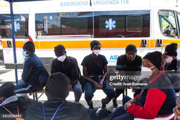 People in solitary confinement after the anti-covid checks carried out during the disembarkation from the Ocean Viking on August 01, 2022 in Salerno,...