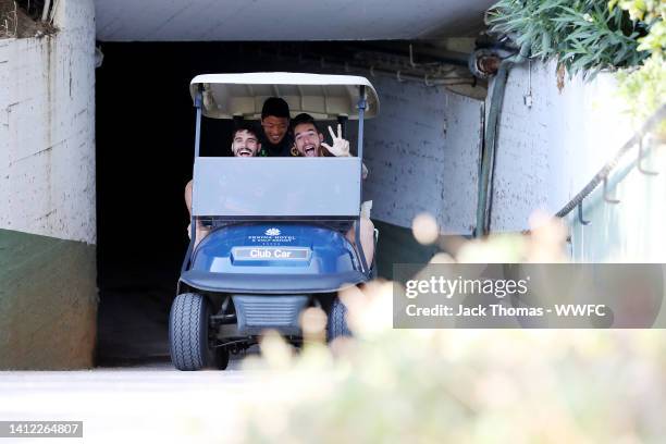 Pedro Neto, Hee-chan Hwang and Jose Sa of Wolverhampton Wanderers make their way to the pitch on a golf buggy ahead of a Wolverhampton Wanderers...