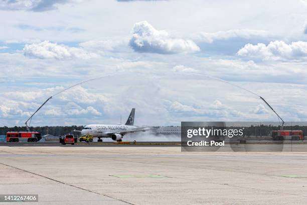 Water is sprayed over the plane of the Germany Women's National Soccer Team after it landed at Frankfurt Airport on August 01, 2022 in Frankfurt am...