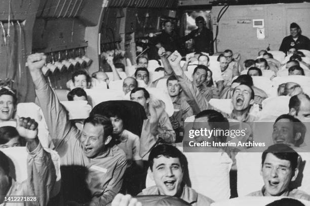 American prisoners of war celebrate as their airplane takes off from an airfield as part of Operation Homecoming, near Hanoi, North Vietnam, February...