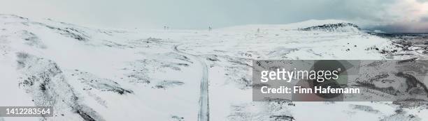 iceland snow covered frozen country road aerial taken photo iceland panorama - central highlands iceland stock pictures, royalty-free photos & images
