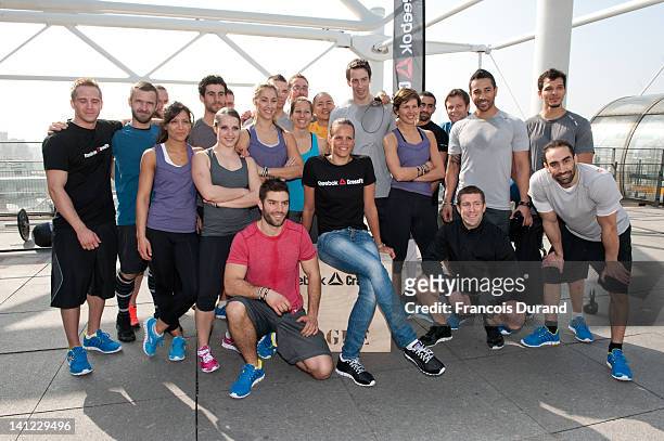 French swimmer Laure Manaudou poses with French CrossFit athletes to launch Reebok's The Sport Of Fitness campaign on March 12, 2012 in Paris,...