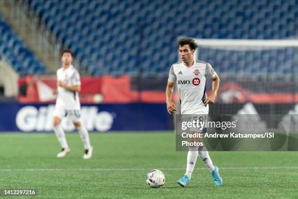 Kobe Franklin of Toronto FC II brings the ball forward during a game between Toronto FC II and New England Revolution II at Gillette Stadium on July...