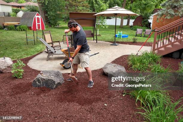 man mulching yard - mulch stock pictures, royalty-free photos & images