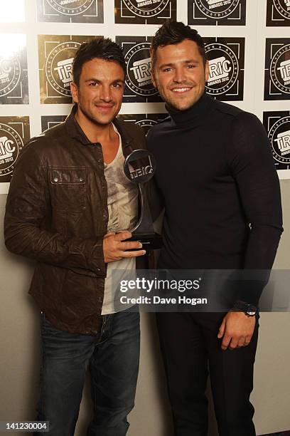 Mark Wright poses with Peter Andre after presenting himn with the Digital TV Personality Award in front of the winners boards at the TRIC Television...