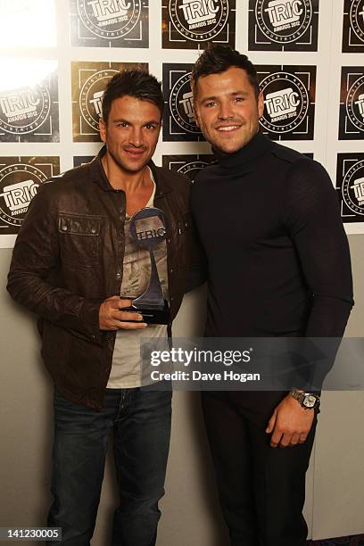 Mark Wright poses with Peter Andre after presenting himn with the Digital TV Personality Award in front of the winners boards at the TRIC Television...