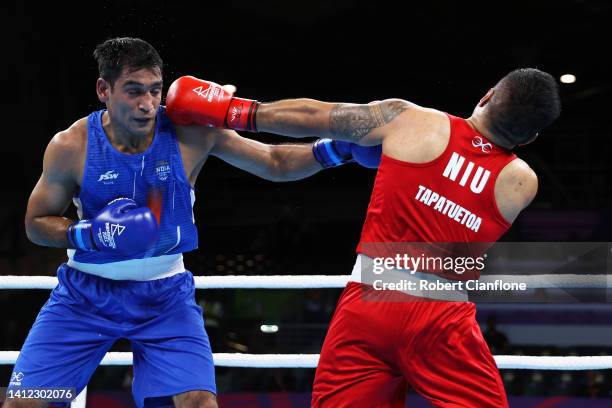 Ashish Kumar Kumar of Team India and Travis Tapatuetoa of Team Niue exchange punches during the Men’s Over 75kg-80kg Round of 16 fight on day four of...