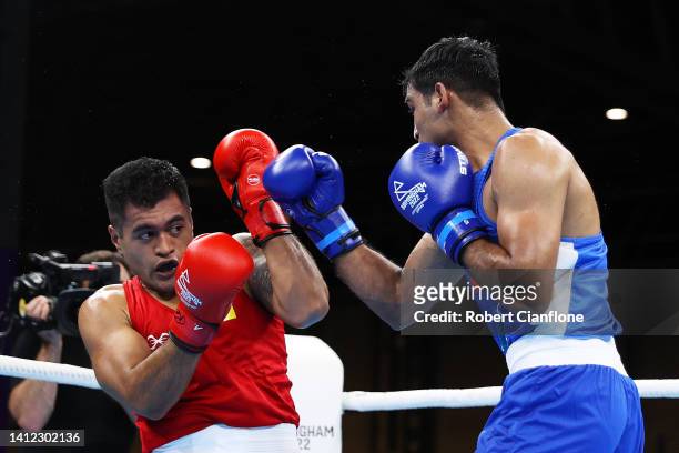 Ashish Kumar Kumar of Team India punches Travis Tapatuetoa of Team Niue during the Men’s Over 75kg-80kg Round of 16 fight on day four of the...
