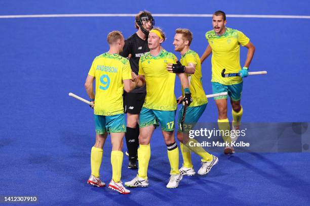 Aran Zalewski of Team Australia celebrates with team mates after scoring their sides sixth goal during Men's Hockey - Pool A match between New...