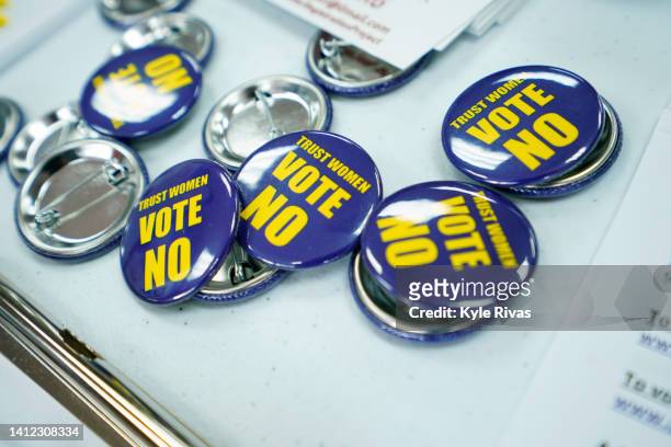 Badges for the Vote No on the Constitutional Amendment on Abortion are laid out for canvassers at the Johnson County Democratic Office on August 01,...