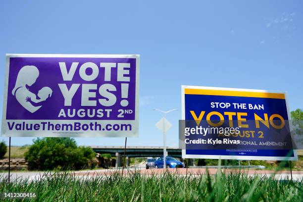 Signs in favor and against the Kansas Constitutional Amendment On Abortion are displayed outside Kansas 10 Highway on August 01, 2022 in Lenexa,...