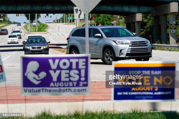 Signs in favor and against the Kansas Constitutional Amendment On Abortion are displayed outside Kansas 10 Highway on August 01, 2022 in Lenexa,...