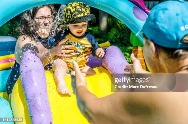 mom and baby boy in toy pool - chubby granny stock pictures, royalty-free photos & images
