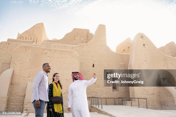 tourists admiring restored ruins of at-turaif near riyadh - saudi arabia national day stock pictures, royalty-free photos & images